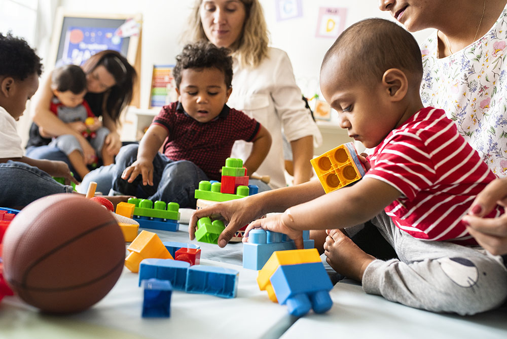 Diverse children enjoying playing with toys at a Preschool & Daycare/Childcare Center serving Apex & Fuquay-Varina, NC