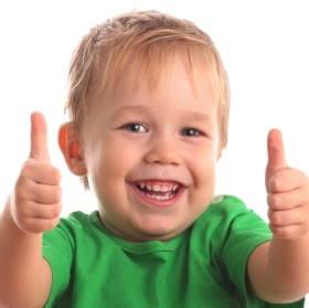 Happy young little kid boy , doing thumbs up, at a Preschool & Daycare/Childcare Center serving Apex & Fuquay-Varina, NC