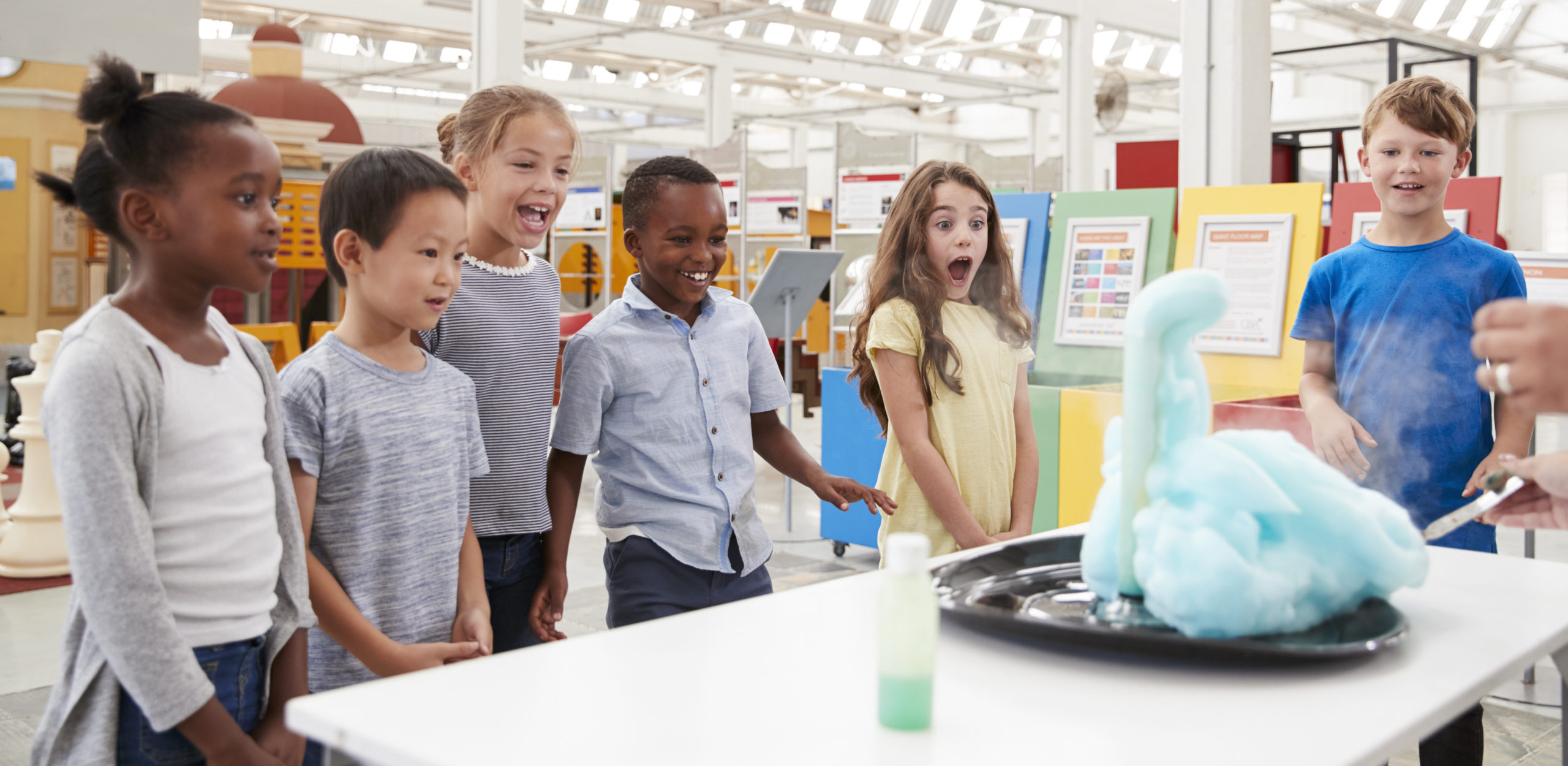 Kids having fun watching an experiment at a science center at a Preschool & Daycare/Childcare Center serving Apex & Fuquay-Varina, NC