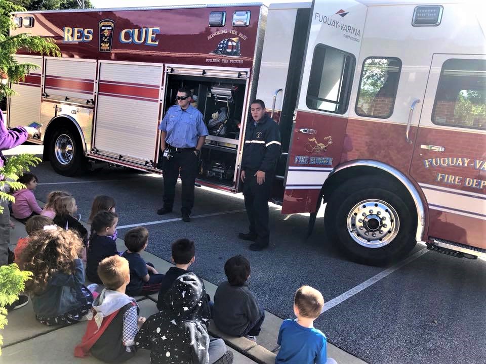 in house visits community, Firefighters in front of children teaching them at a Preschool & Daycare/Childcare Center serving Apex & Fuquay-Varina, NC