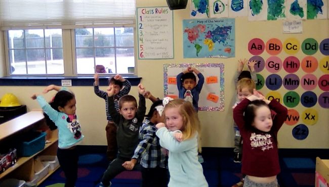 Preschoolers doing some activity inside the room building creative at a Preschool & Daycare/Childcare Center serving Apex & Fuquay-Varina, NC