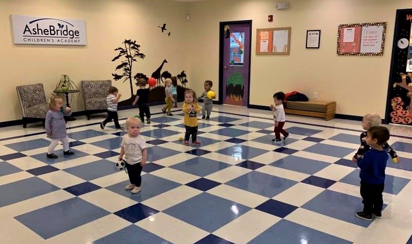 Toddlers on a large room playing at a Preschool & Daycare/Childcare Center serving Apex & Fuquay-Varina, NC