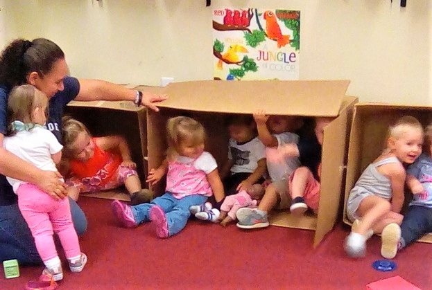 Toddlers playing inside big boxes at a Preschool & Daycare/Childcare Center serving Apex & Fuquay-Varina, NC